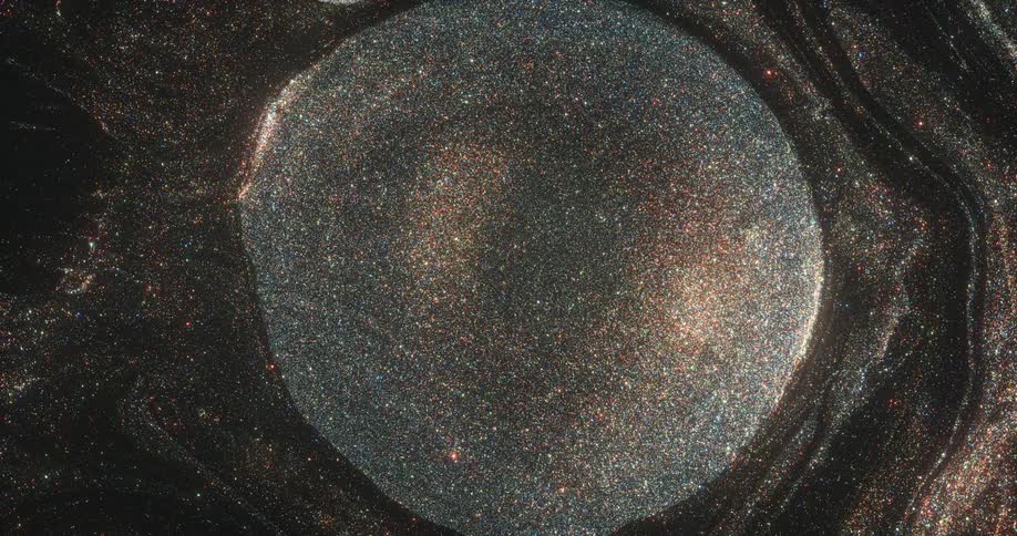 An orb of golden glitter is moving out of a portal in an organic sparkling universe