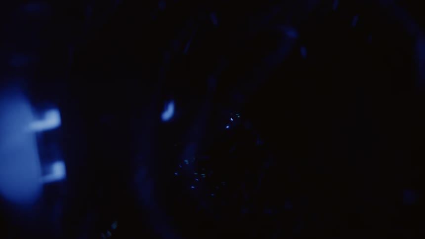 A person with a lit up mask on dances
