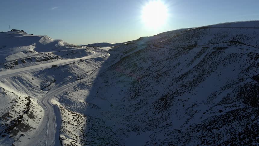 Aerial view of a mining quarry covered in snow at evening