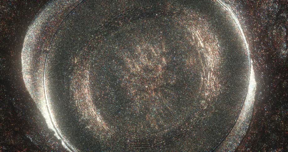 Light and glitter move outwards in an explosion of fluid