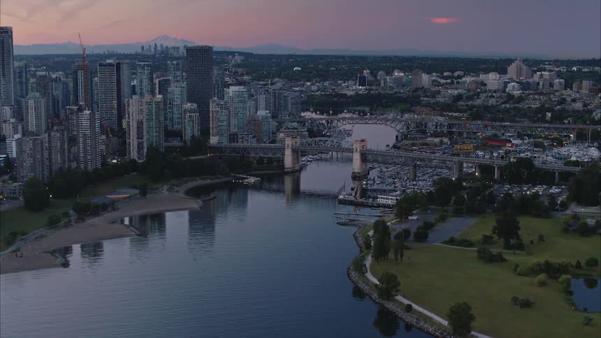 Aerial view of a river going through a waterfront city at evening