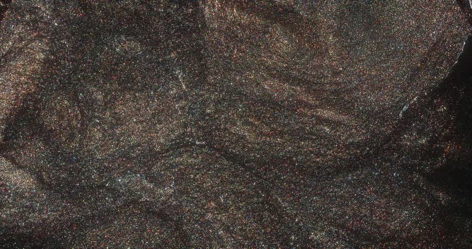 Metallic glitter sparkles in mixture as it flows