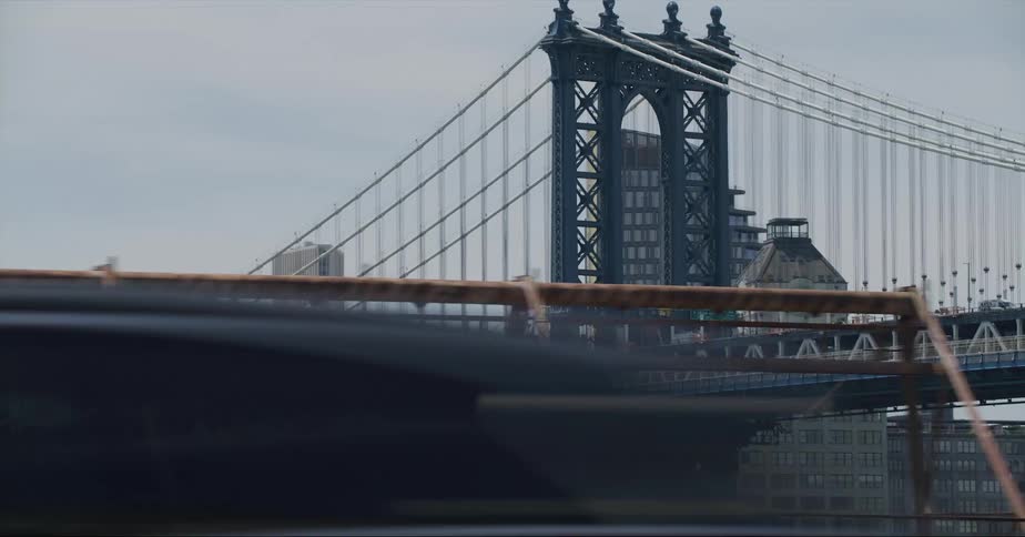 Suspension bridge with the tower and cables seen from car moving on highway