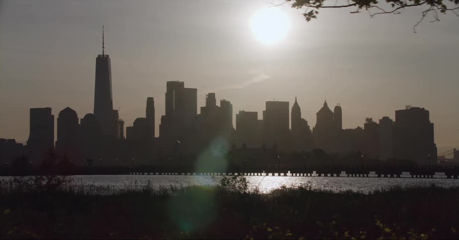 Silhouette of tall skyscrapers on the city skyline under the sun