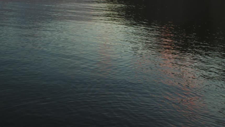 Light reflects on the water as it ripples and moves