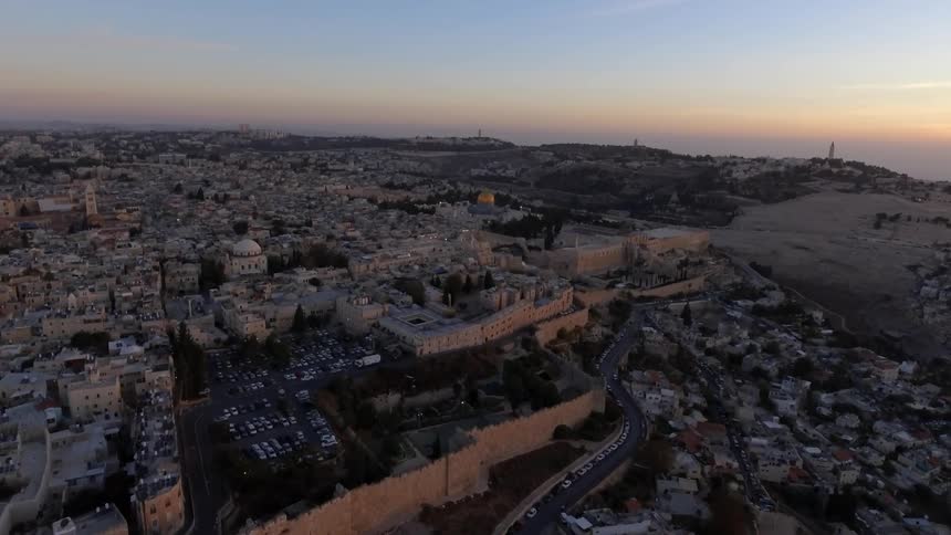 A densely populated city at sunset
