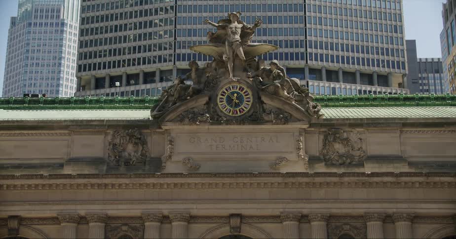 A historic building sits below tall modern skyscrapers