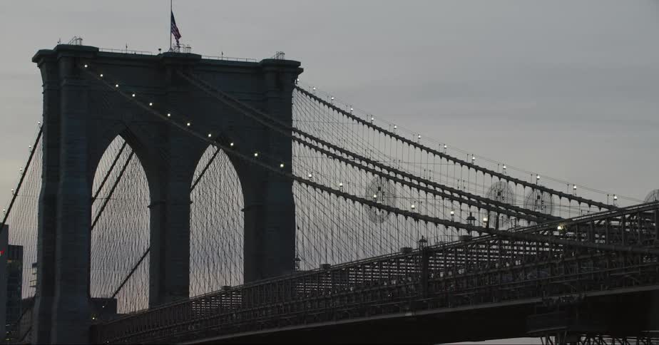 A helicopter flies over a bridge in a city