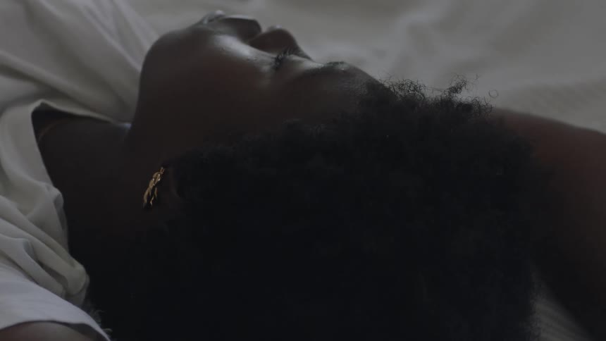 A woman naps with her arms over her head