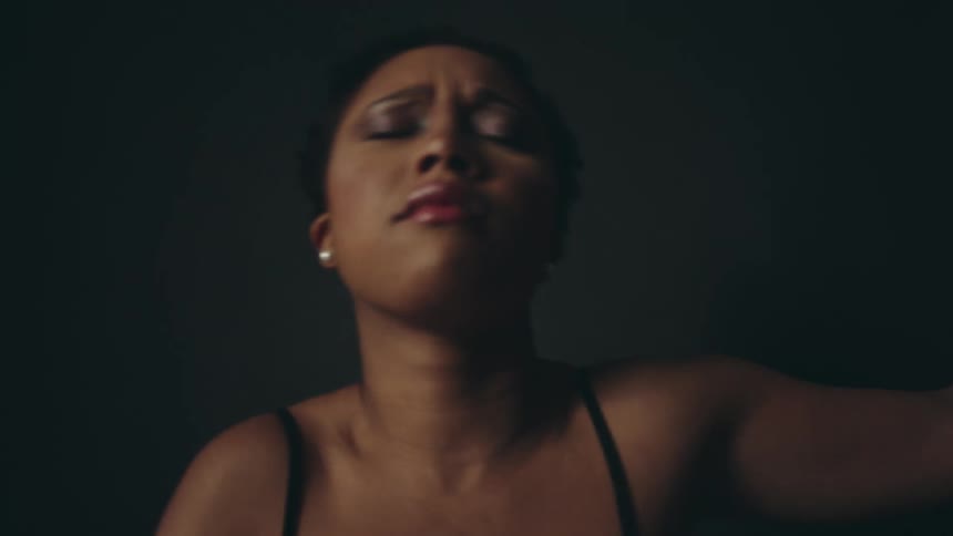 Inspired black woman dancing by herself