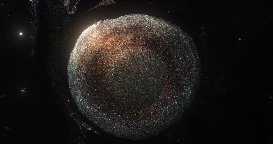 An orb of bronze and golden glitter emerges from the darkness and sparkles as it grows
