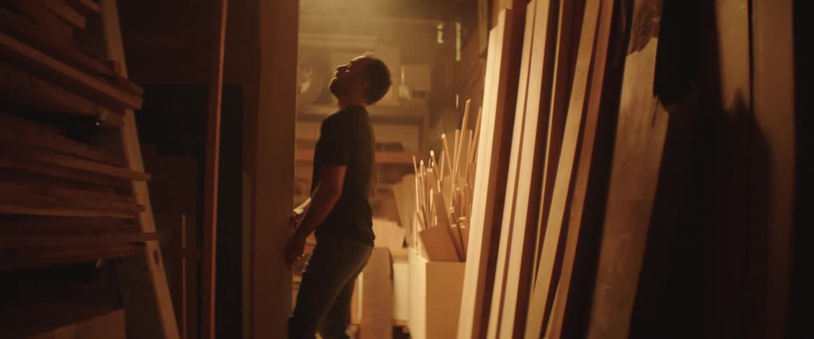 A man is looking for a piece of wood in a shop