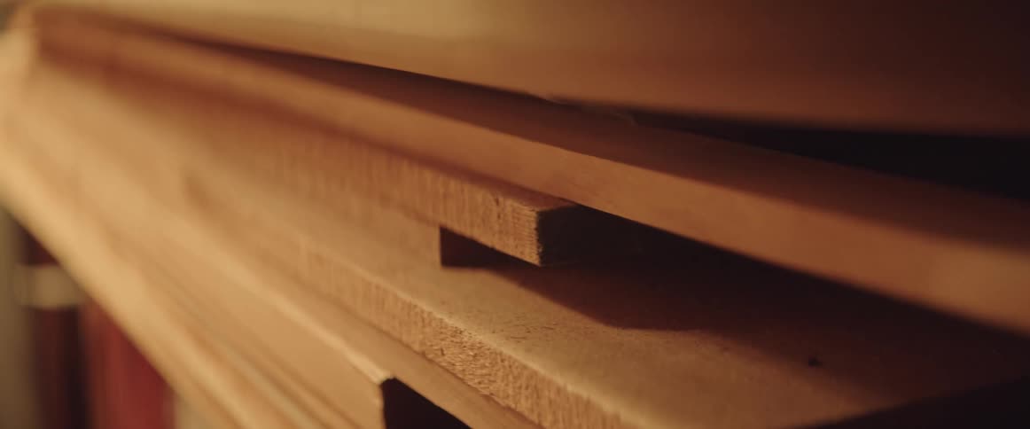 Close up of piled up wooden planks in a storage area