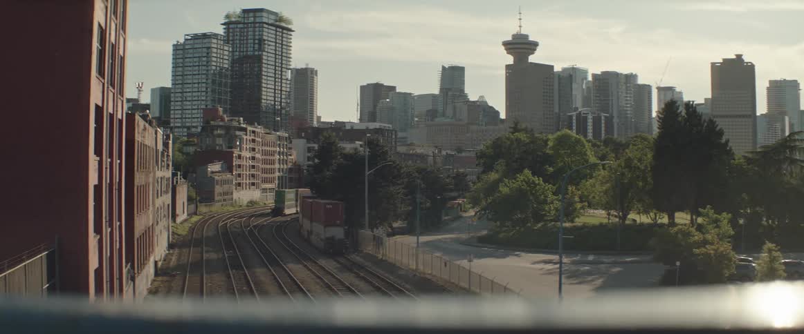 Multiple sets of railroad tracks run towards downtown Vancouver