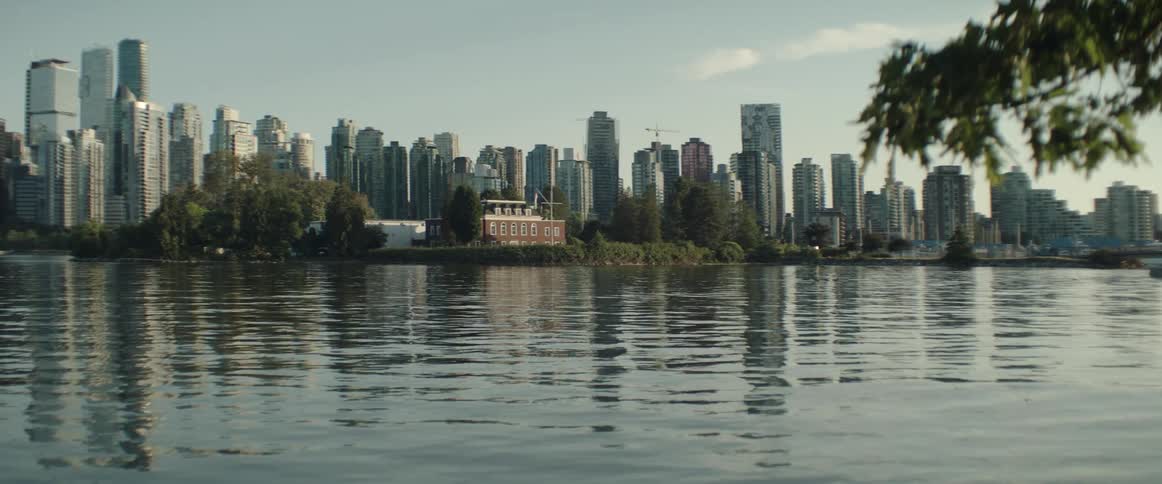 A downtown city skyline sits along a waterfront