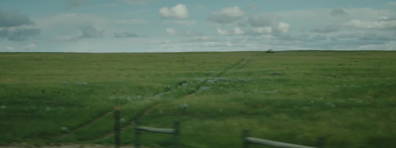 A view of grass plains outdoors under blue sky