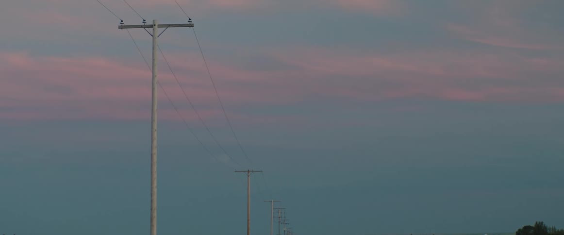 The top of power lines at dusk