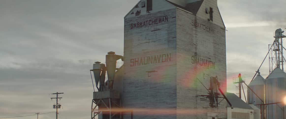 Antique grain storage building in the countryside at sunset