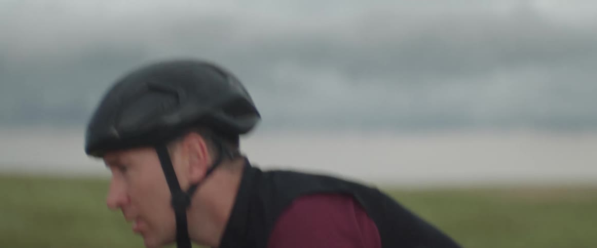 Focused man wearing a bike helmet riding his bicycle on the road