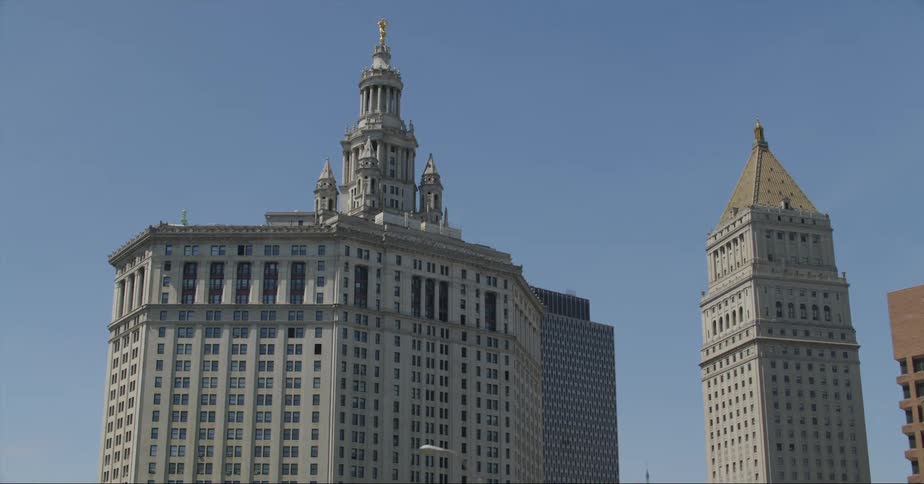 Manhattan municipal building in new york city and a tower under a clear sky