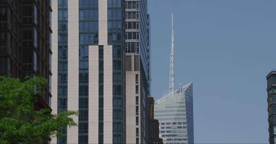 A spire extends from the top of a skyscraper