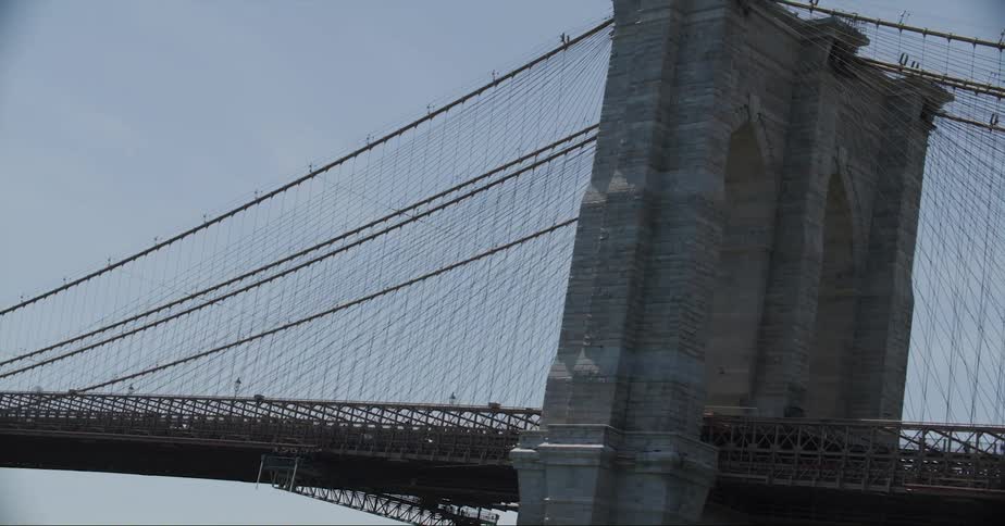 Vehicles cross suspension bridge through the tower