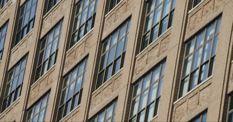 Windows on the facade of a tall building in the city