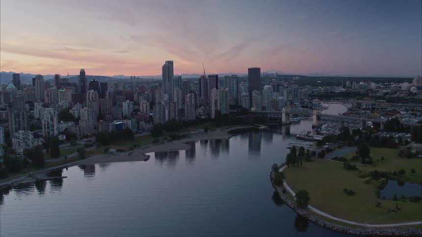 Aerial view of a river going through a city at sunrise