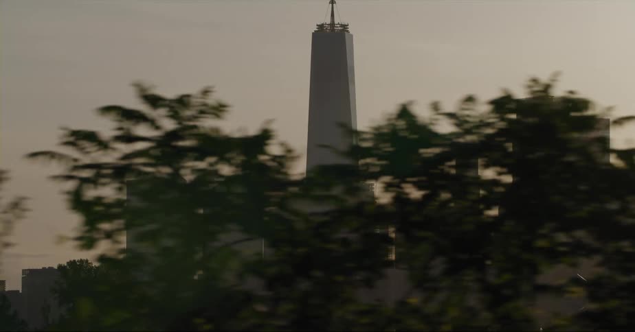 City skyline with high rise buildings and skyscraper being silhouetted against the sky at sunset