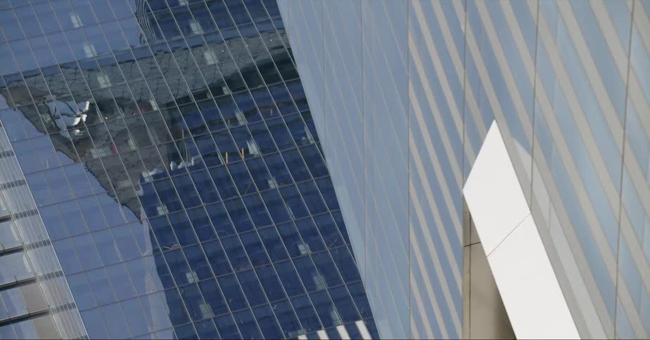 Glass facade of tall skyscrapers in the city skyline at daytime