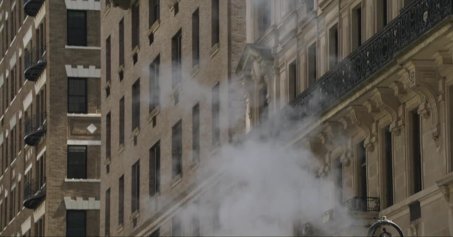 Column of steam rises from the street in new york city
