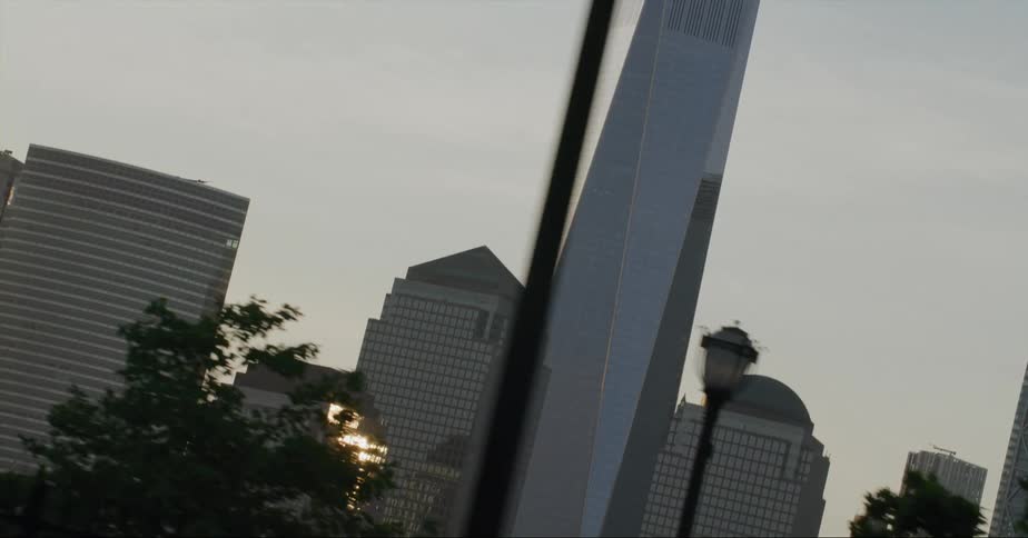 Sunlight reflects off the windows of a large building in a city