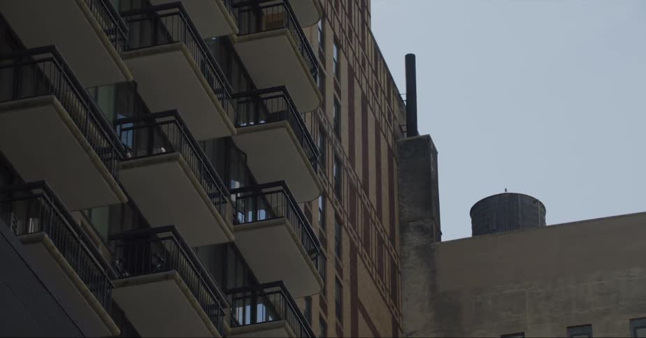 One residential building is located close to another towering building