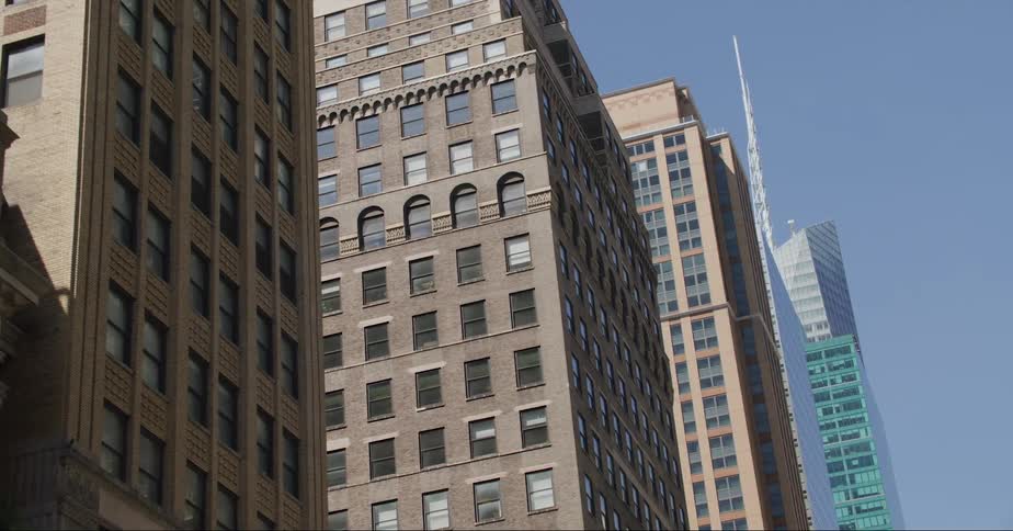 High rise buildings and skyscraper with spire against blue sky in the city