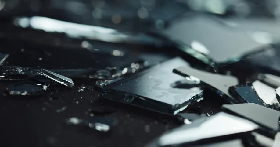 The ground is littered with fragments of broken glass at crime scene