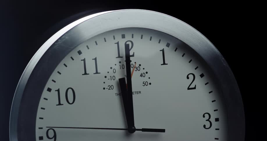 A sleek looking mechanical clock face shows the seconds hand ticking around it