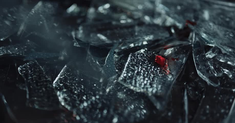 Glass shards reflect a red flashing light