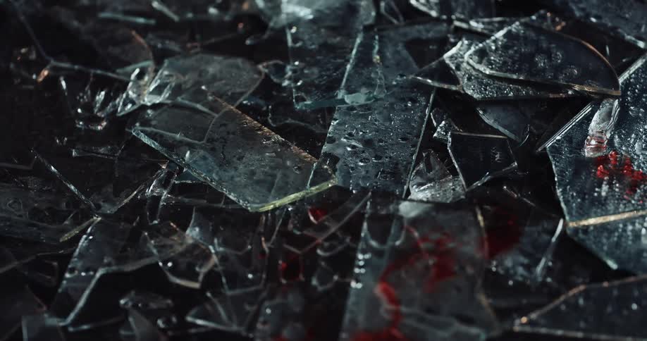 A view of broken glass with red and blue lights flashing