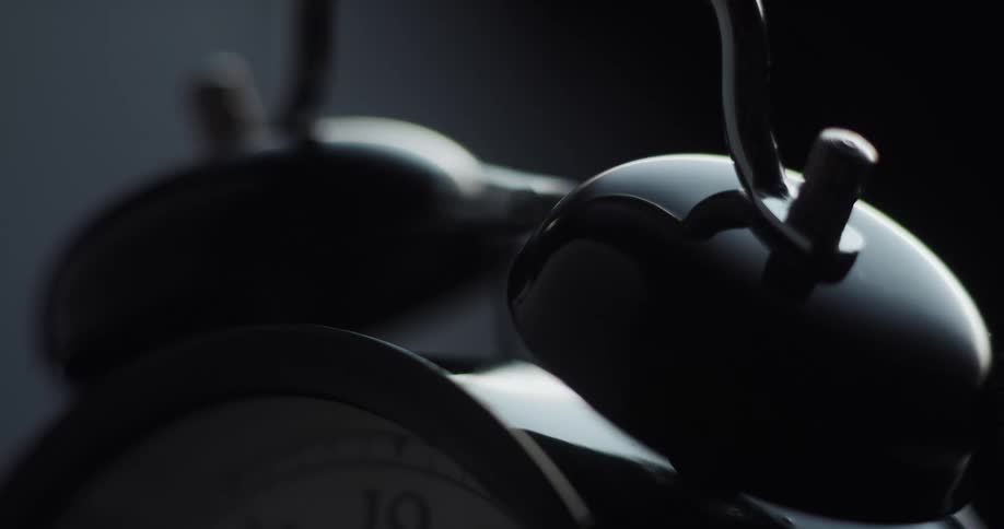 The small hammer of an alarm clock is dinging against the bells