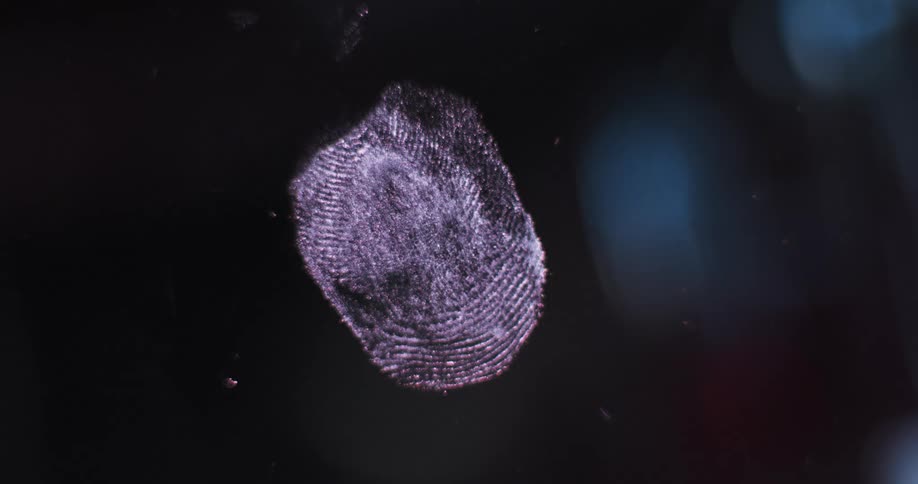 Red and blue lights flash over fingerprint on glass surface