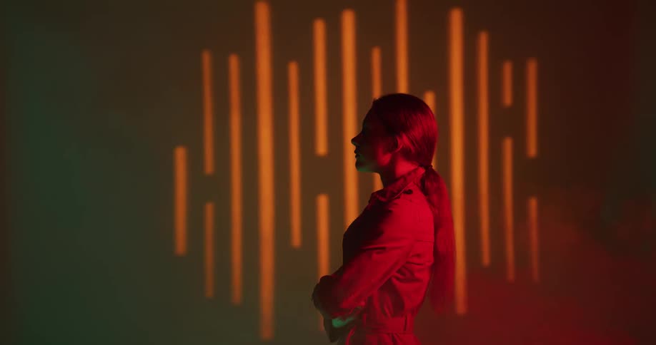 A woman is standing in a room by herself