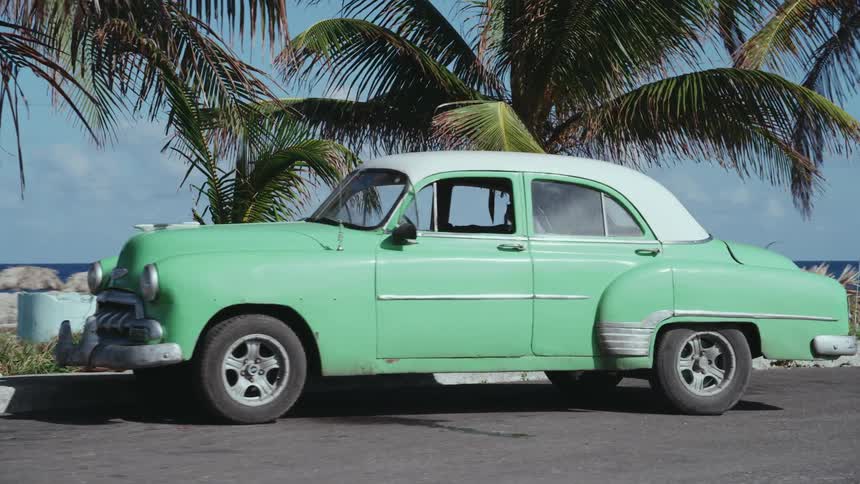 A vintage car parked on the coast