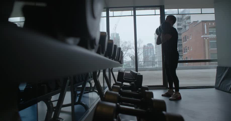 A man lifts weights at the gym