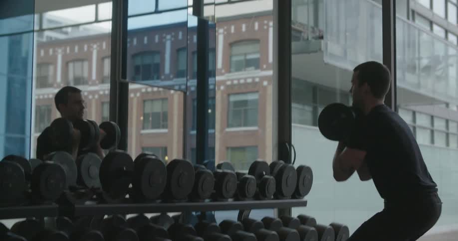 A man lifts weights at the gym