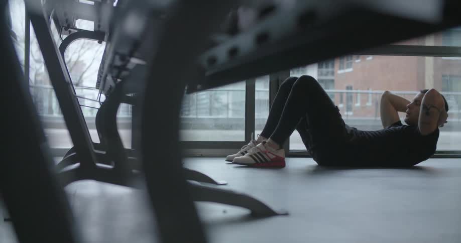 A man does crunches in a fitness room