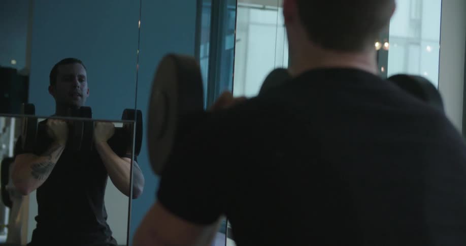 A man works out with weights at the gym