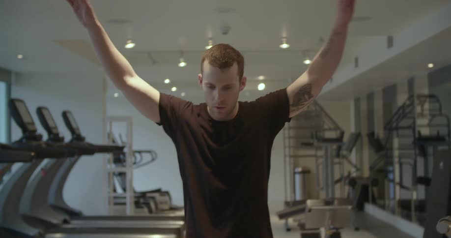 A man stretches at the gym