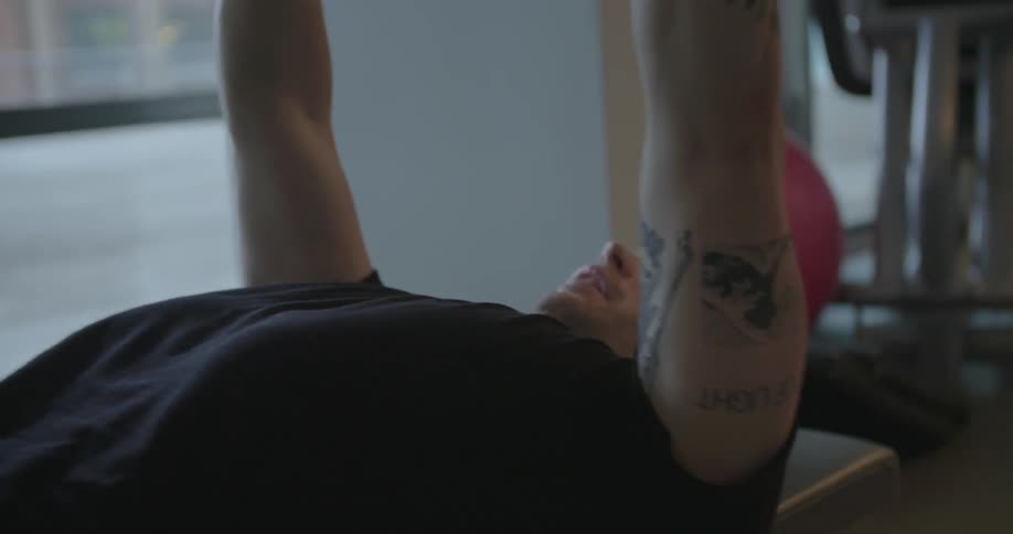 A man lifts weights in a fitness room