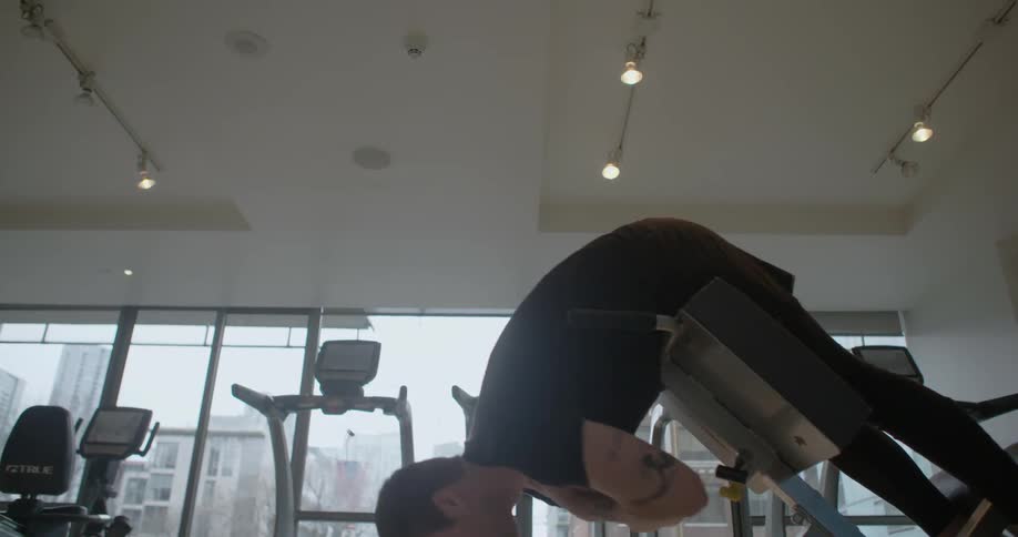 A man is exercising in a gym