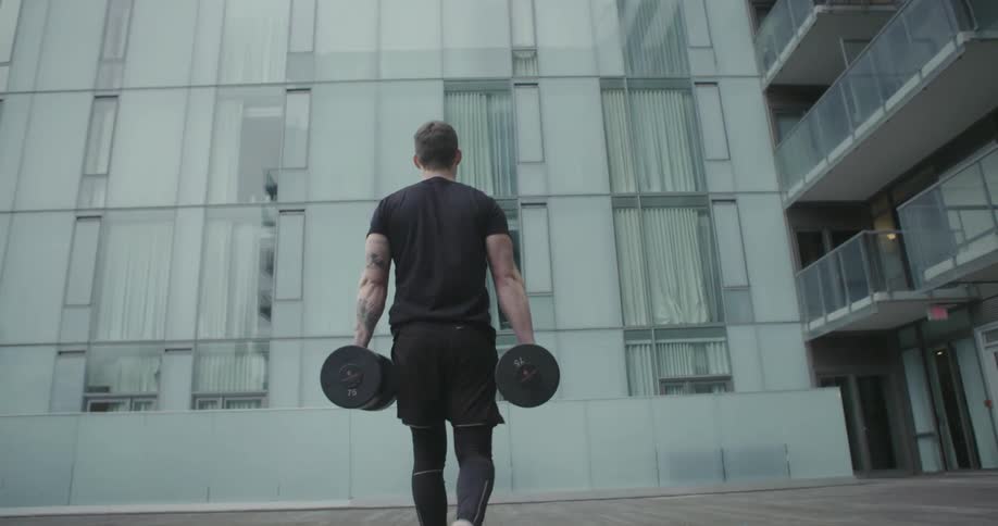Athlete carrying weights towards a wall